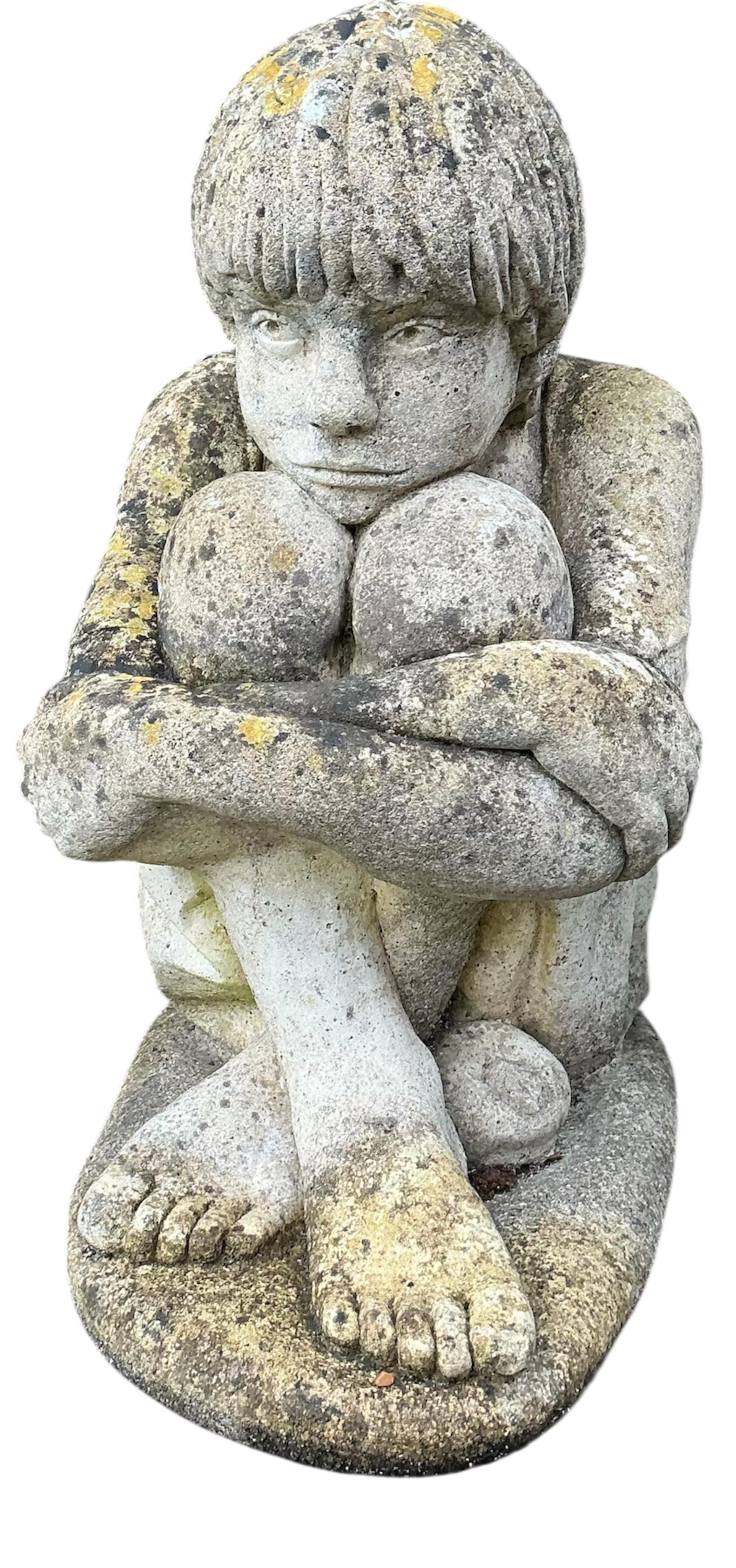 Two reconstituted stone seated child garden ornaments, larger height 56cm